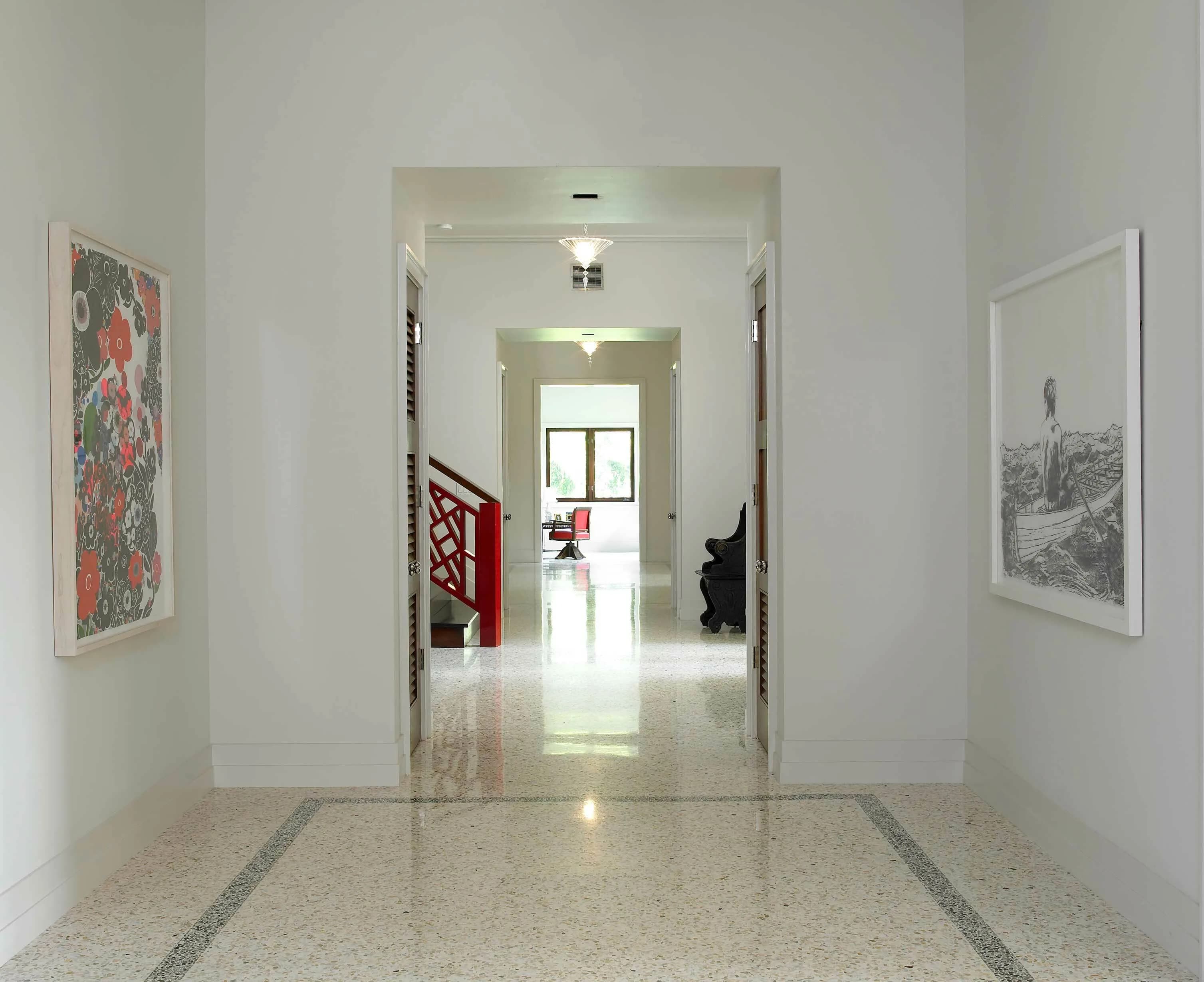 Coral Gables villa hallway with a polished terrazzo floor and a bordered inlay
