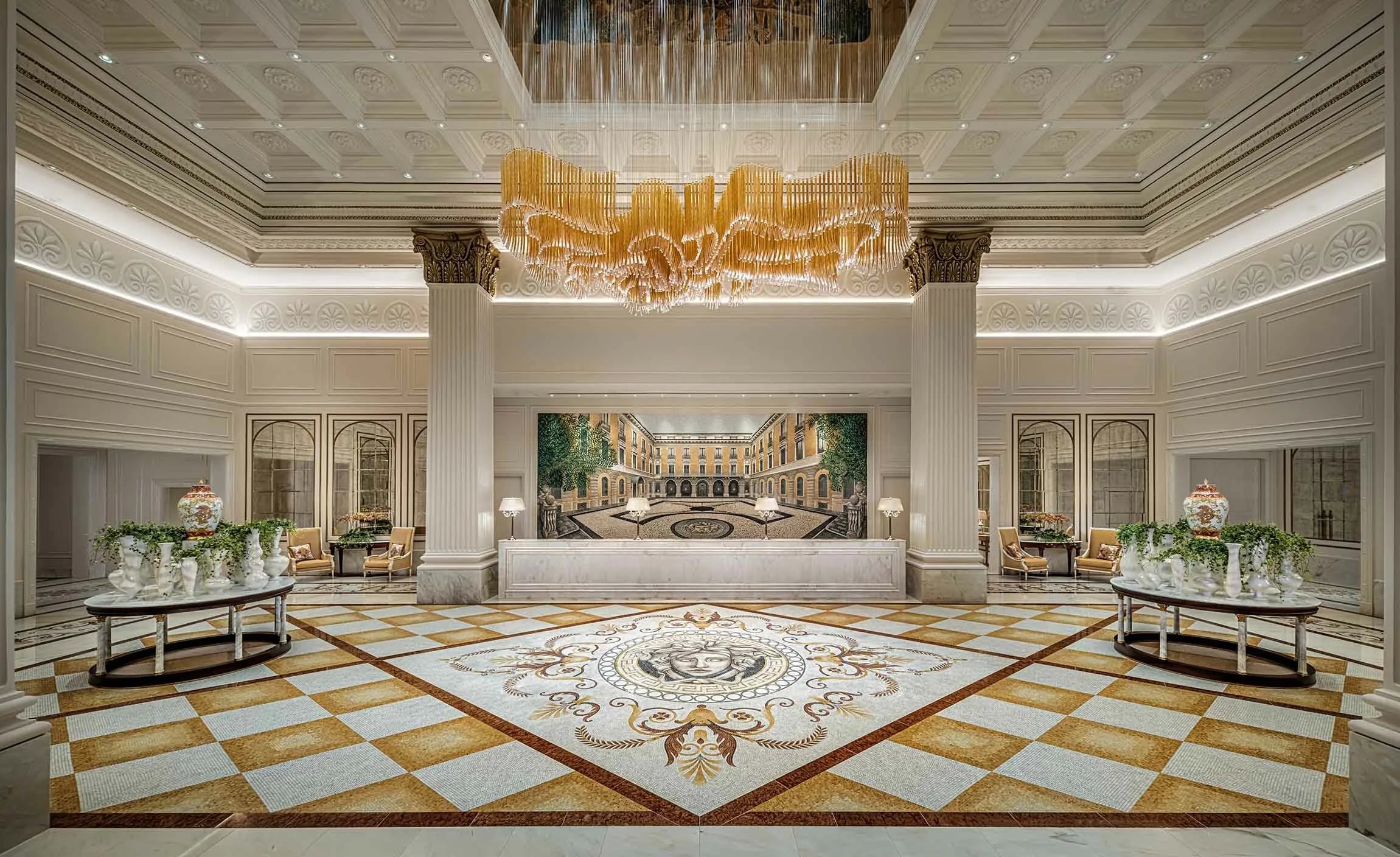 Palazzo Versace Macau lobby with a marble mosaic Medusa floor under a gold chandelier