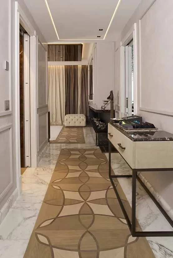 Hallway with an inlaid wood and marble floor