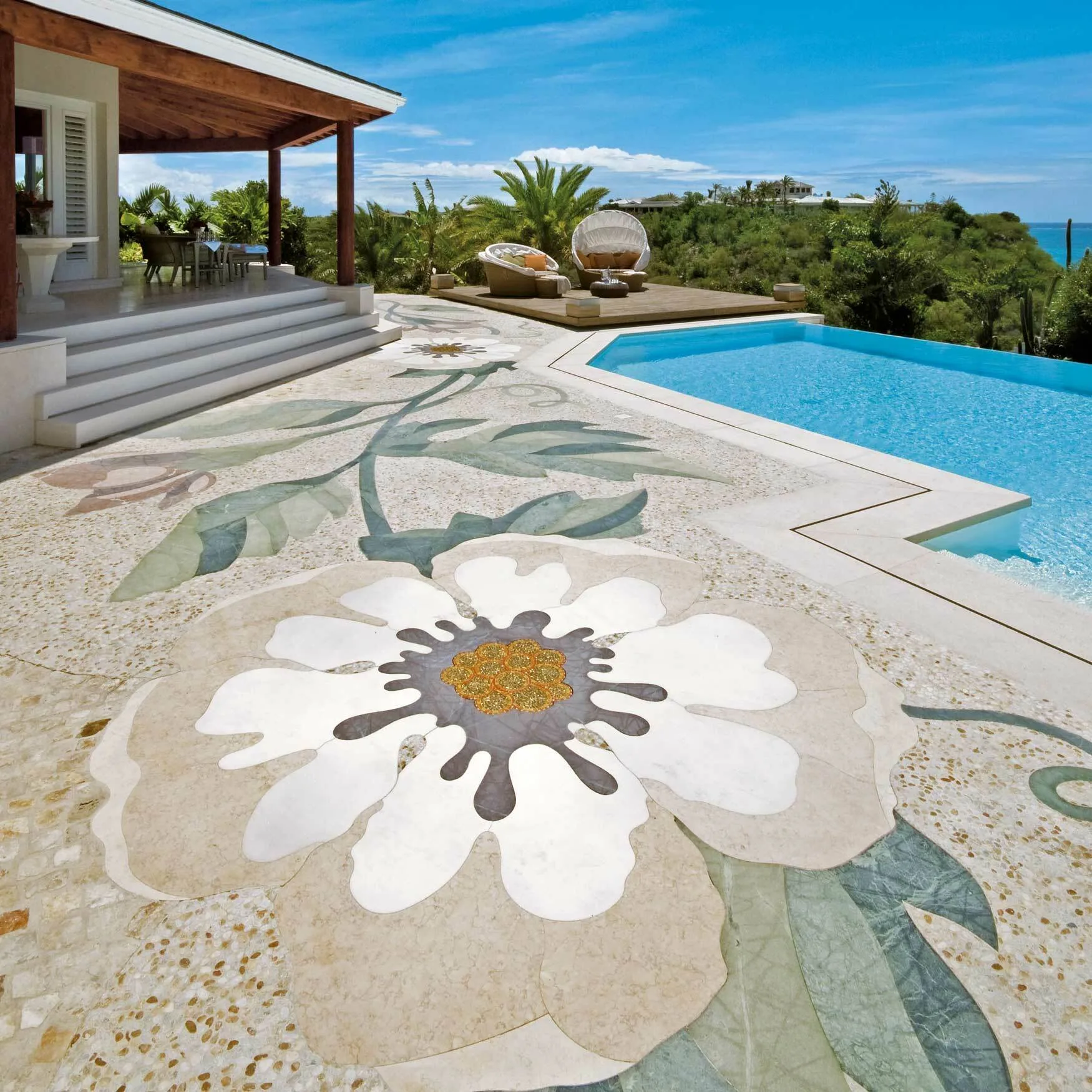 Floral marble mosaic pool deck beside the infinity pool