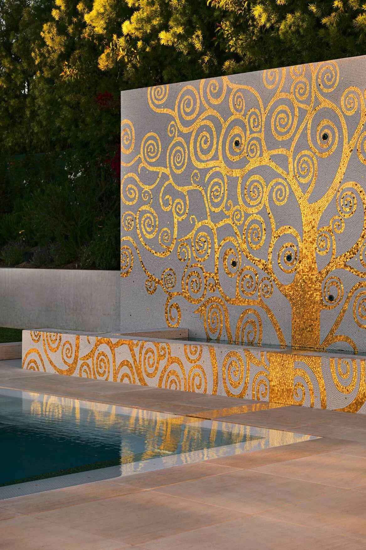 Gold mosaic detail flowing into the pool
