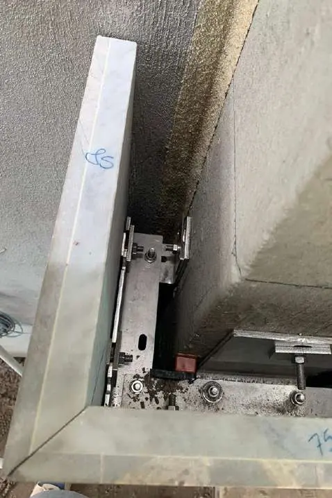 Close view of an anchor bracket supporting a stone panel