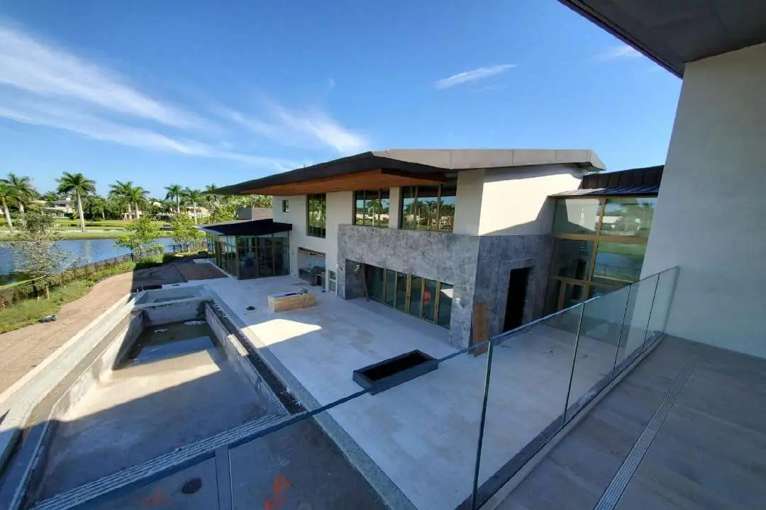 Courtyard with a reflecting pool set against the stone-clad house