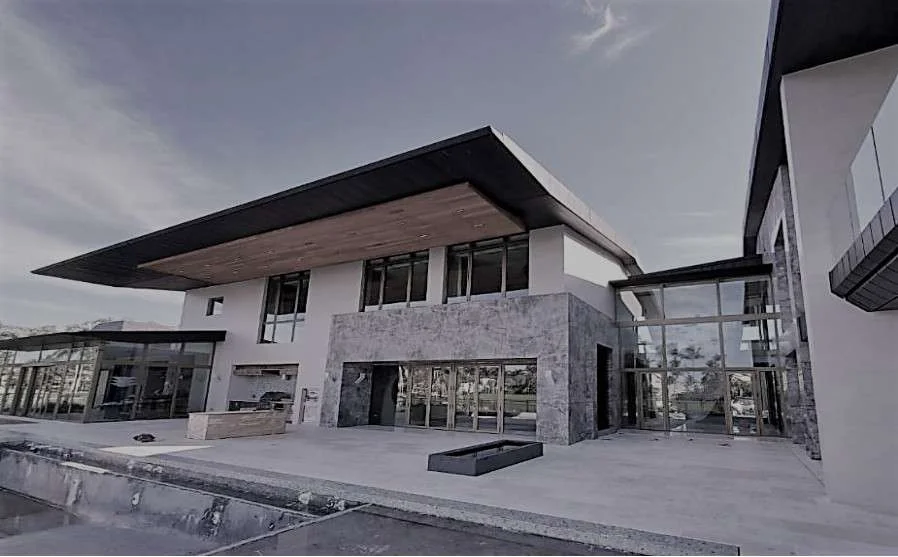 Contemporary villa in Boca Raton clad in grey Fior di Bosco stone, seen from the front approach