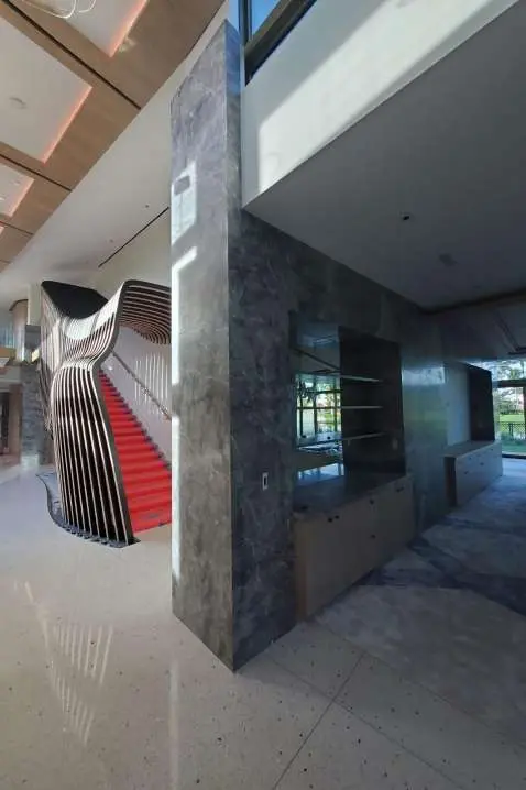 Interior view with a staircase behind stone-clad columns
