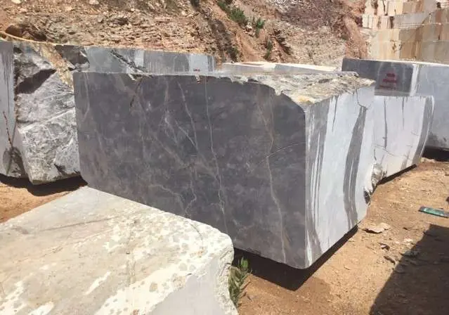 Raw stone blocks resting on the quarry floor