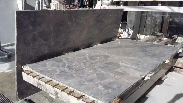 Stone slab positioned on a cutting bench