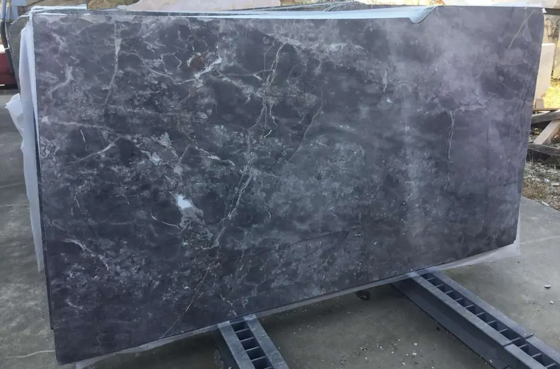 Cut grey stone slab stored on a rack in the workshop