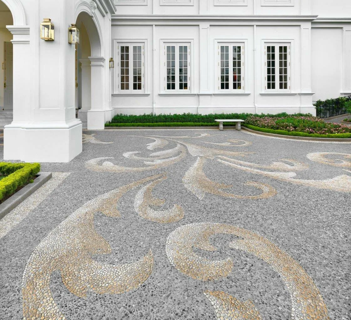 White classical mansion in Colombo with a pebble mosaic driveway of baroque scrollwork