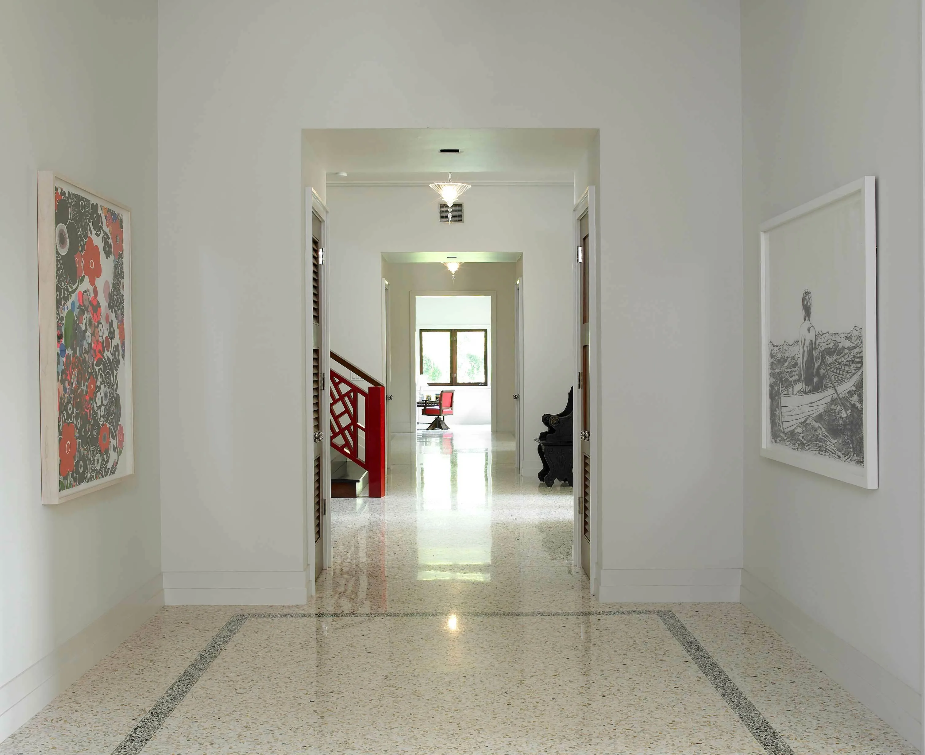 Coral Gables villa hallway with a polished terrazzo floor and a bordered inlay