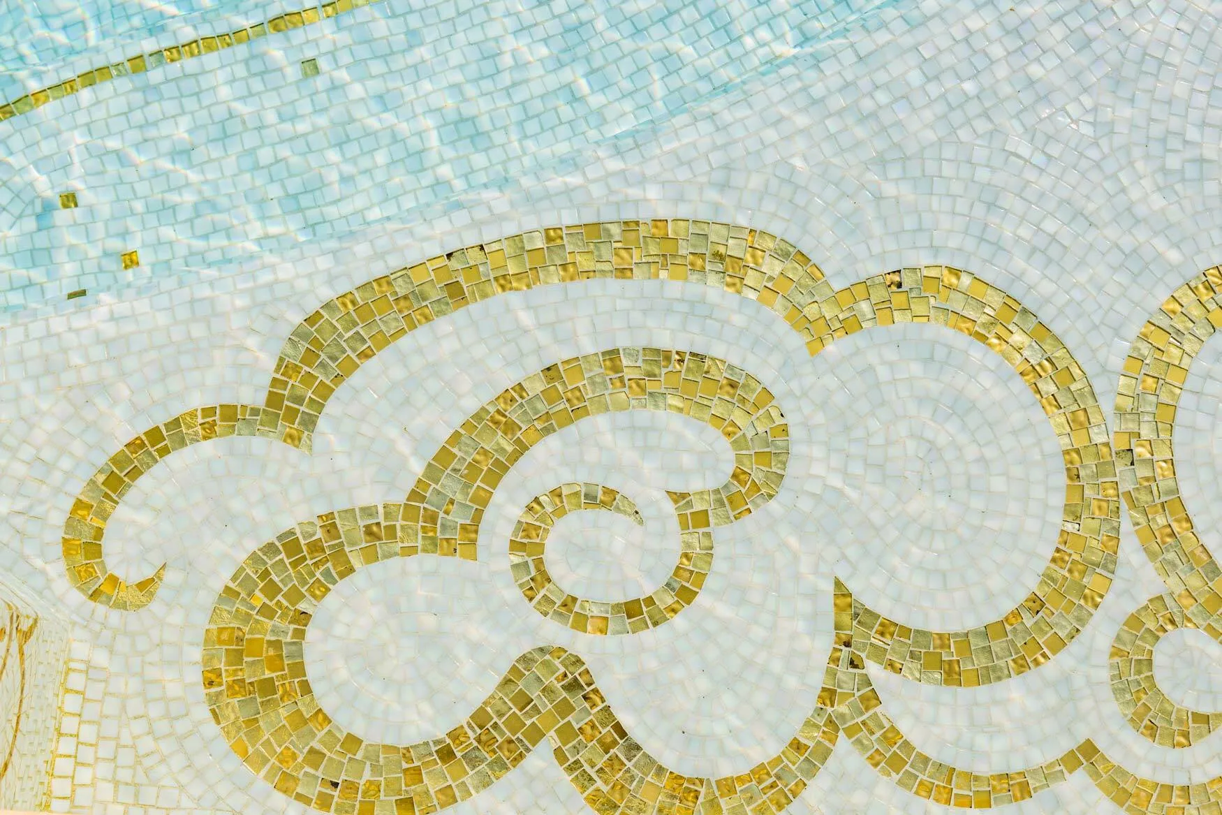 Close-up of the gold and white glass mosaic cloud pattern