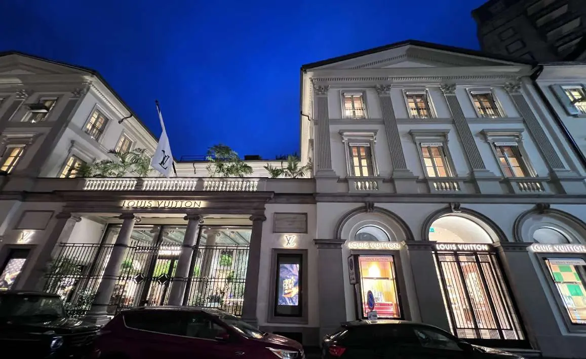 Historic boutique facade lit at night