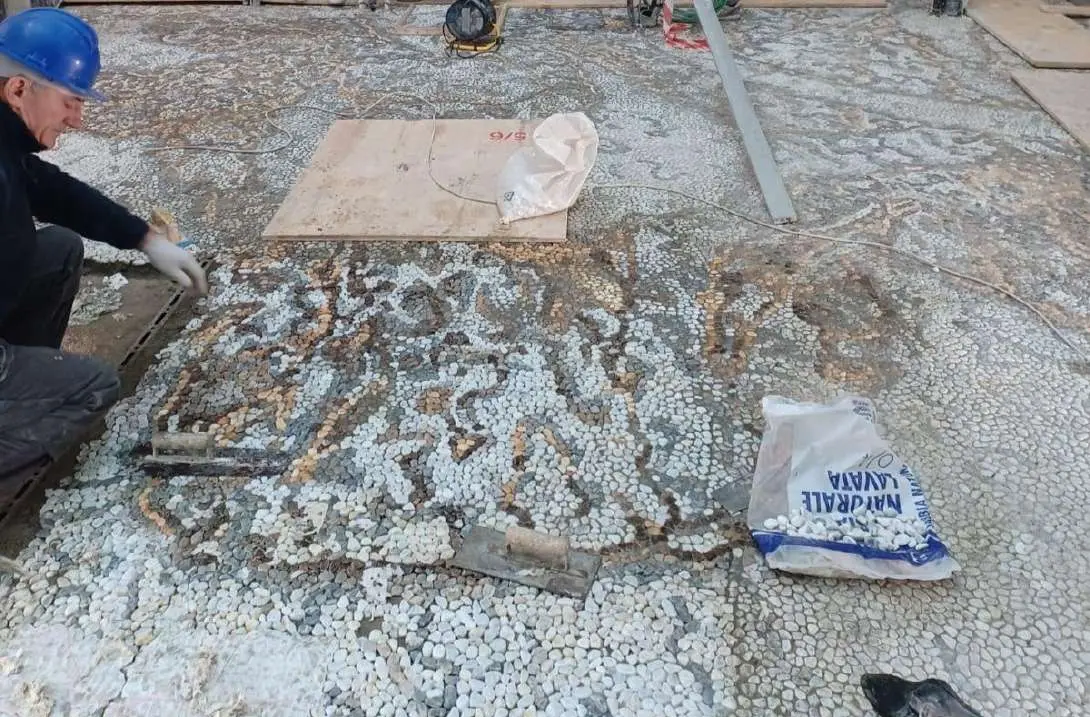 Courtyard mosaic floor being laid by hand