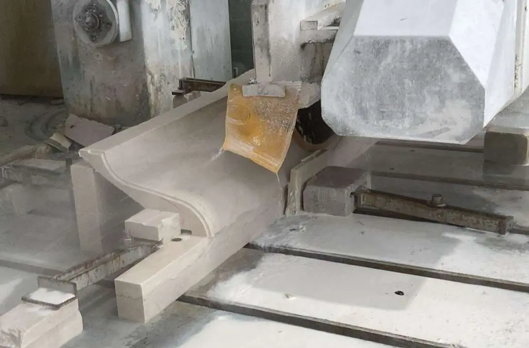 Curved marble stair element being finished in the workshop