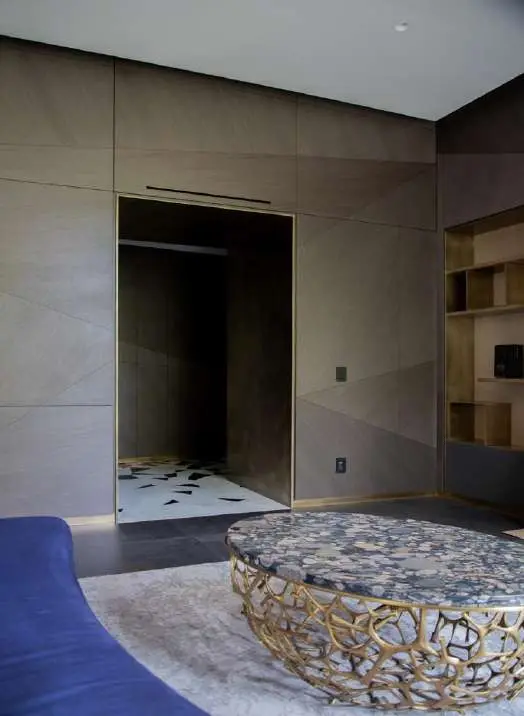 Living space with a round terrazzo table and a blue sofa