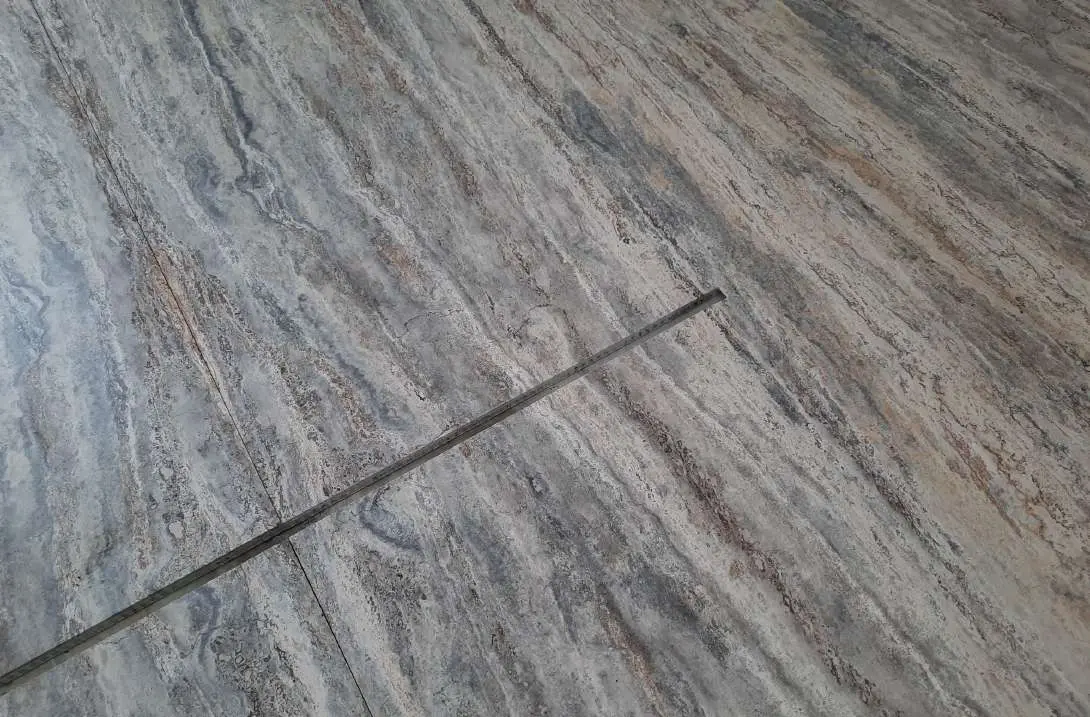 Close view of a joint between dry-laid travertine panels
