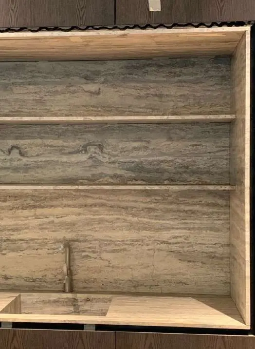 Illuminated travertine shelving niche