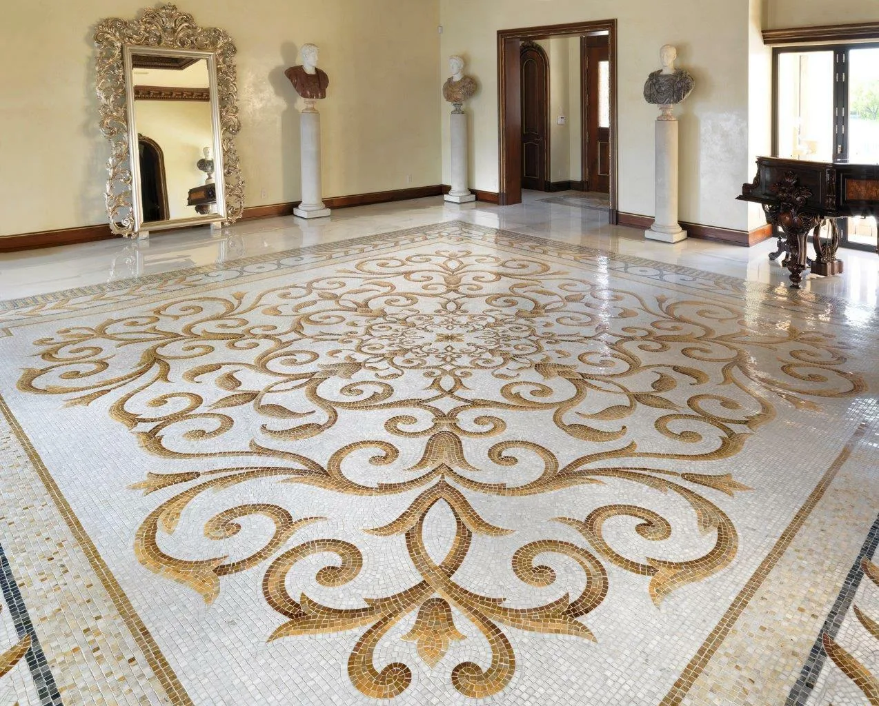 Reception room with a gold and cream artistic mosaic floor at the Venetian Causeway villa