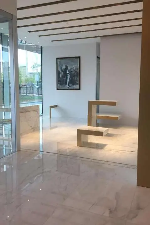 Open area with vertical marble fins and display benches