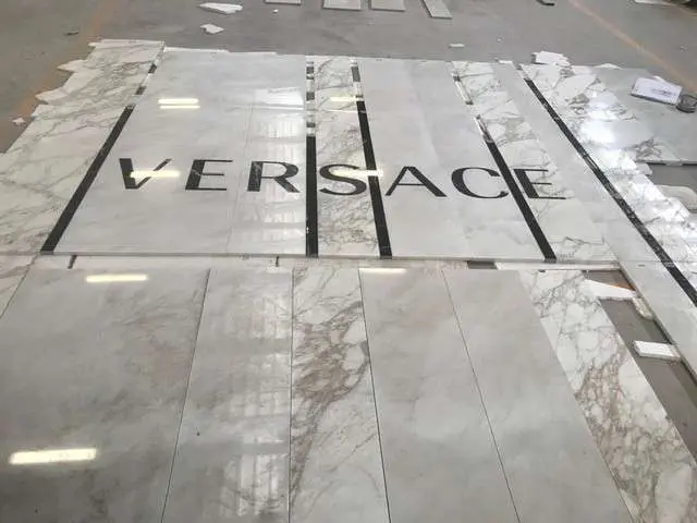 Versace lettering laid out in marble on the floor for inspection