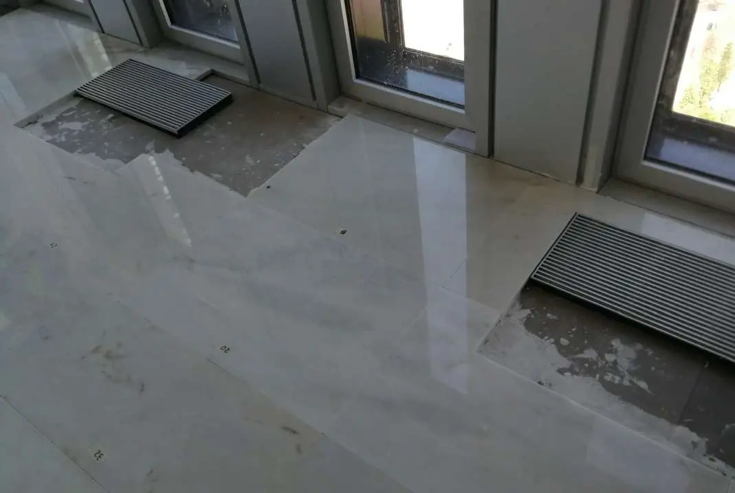 Marble floor installation in progress across an office floor