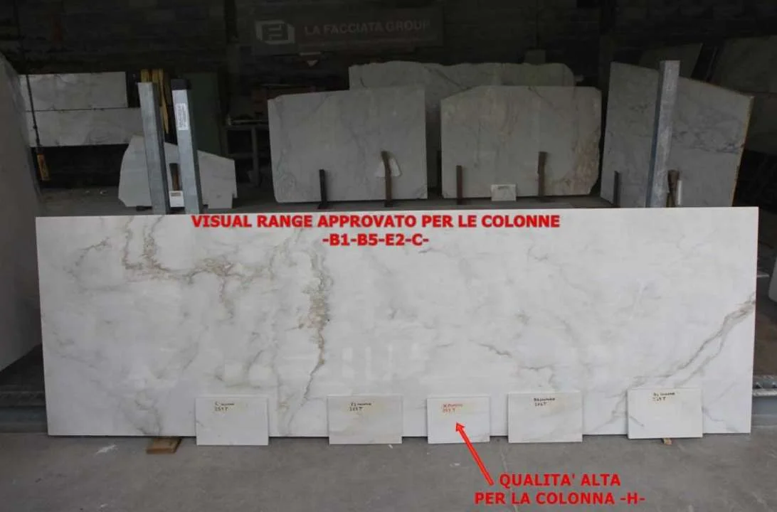 Large marble slab in the workshop with red annotations approving the visual range for the columns