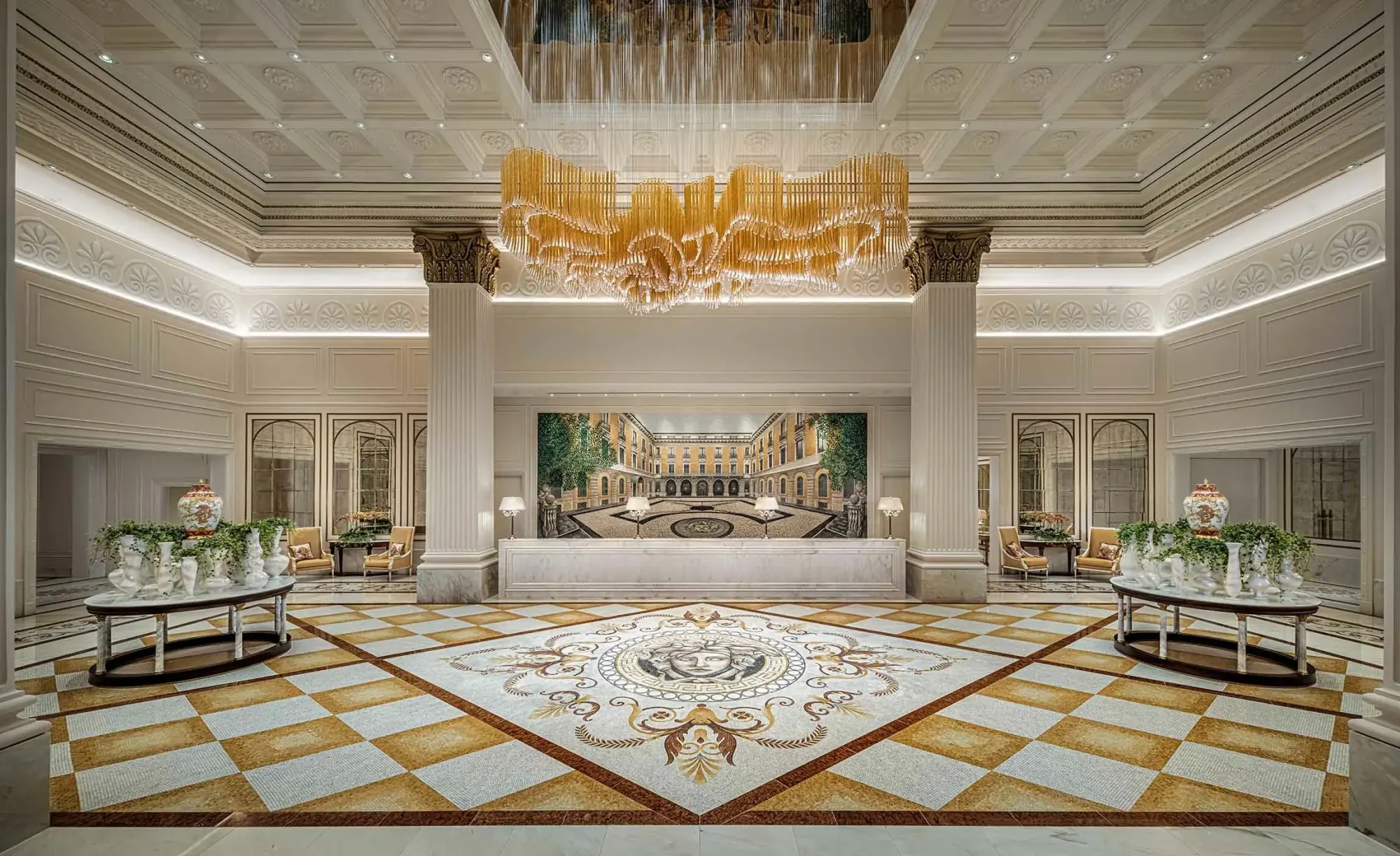 Palazzo Versace Macau lobby with a marble mosaic Medusa floor under a gold chandelier