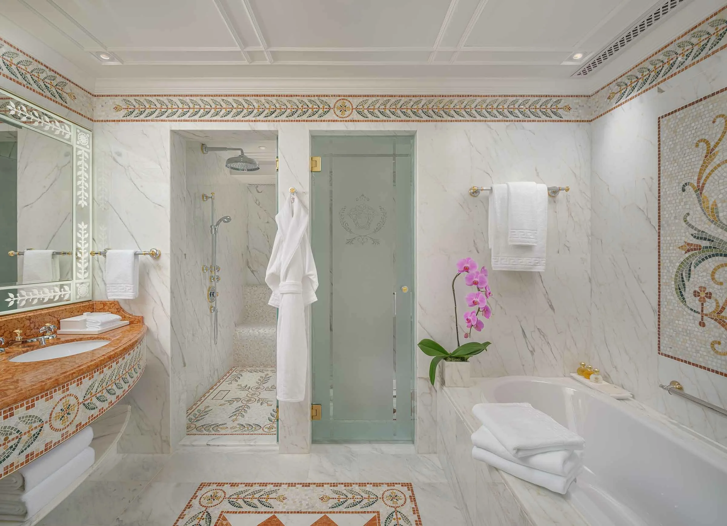 Standard suite bathroom clad in marble with mosaic detailing