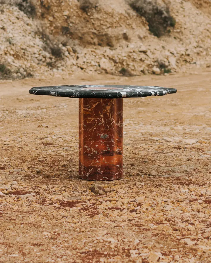 Round marble dining table with a scalloped top